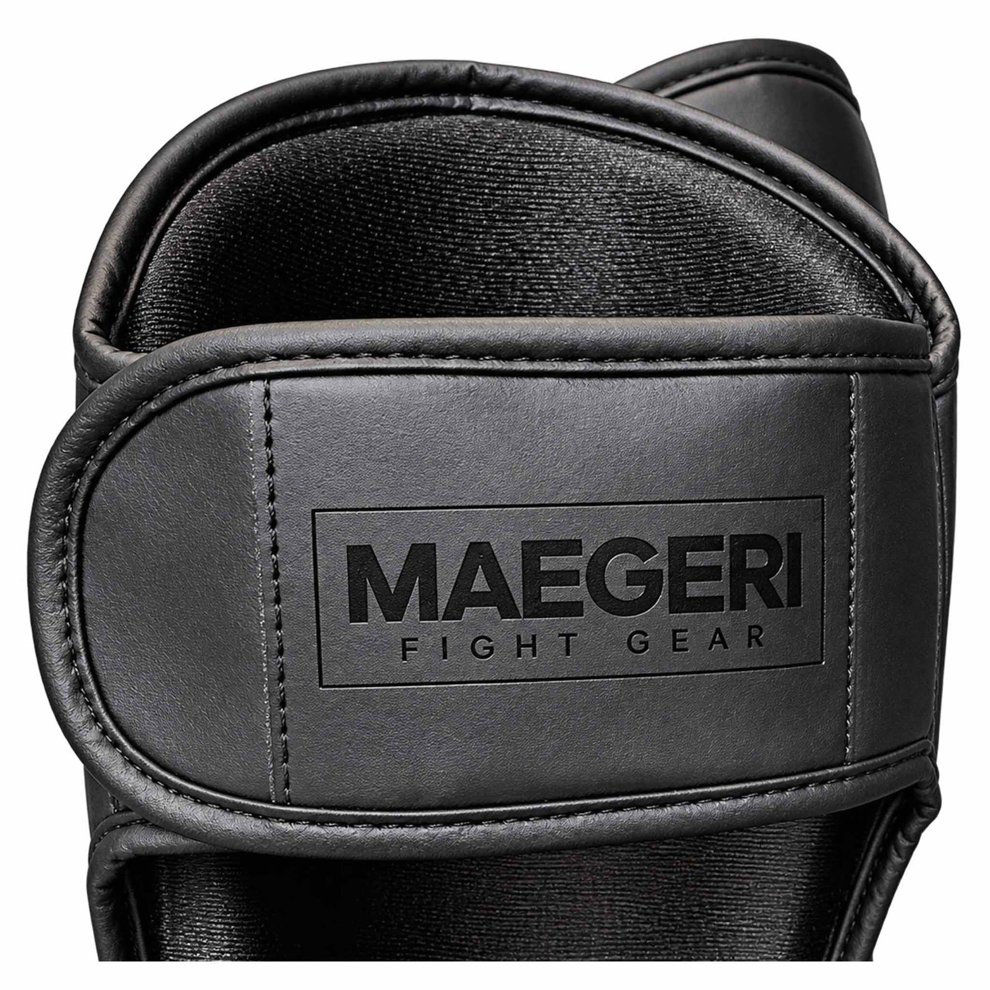 Maegeri MMA shin guards in black - label with logo